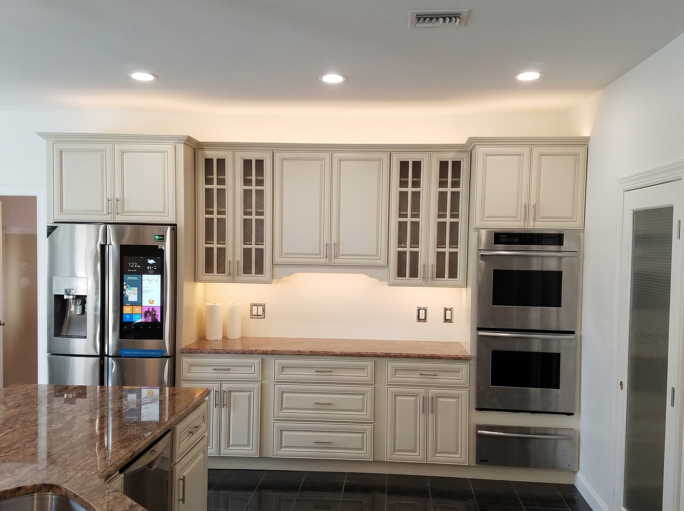 Farmhouse sink, subway tile backsplash, and white cabinets after a kitchen remodel in Doylestown