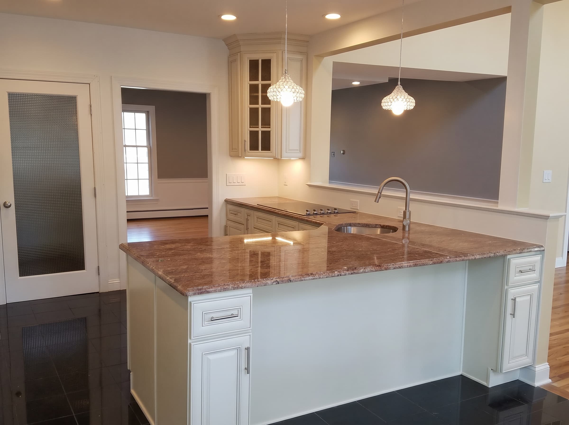 Finished Chalfont kitchen with cream cabinetry and stone counters