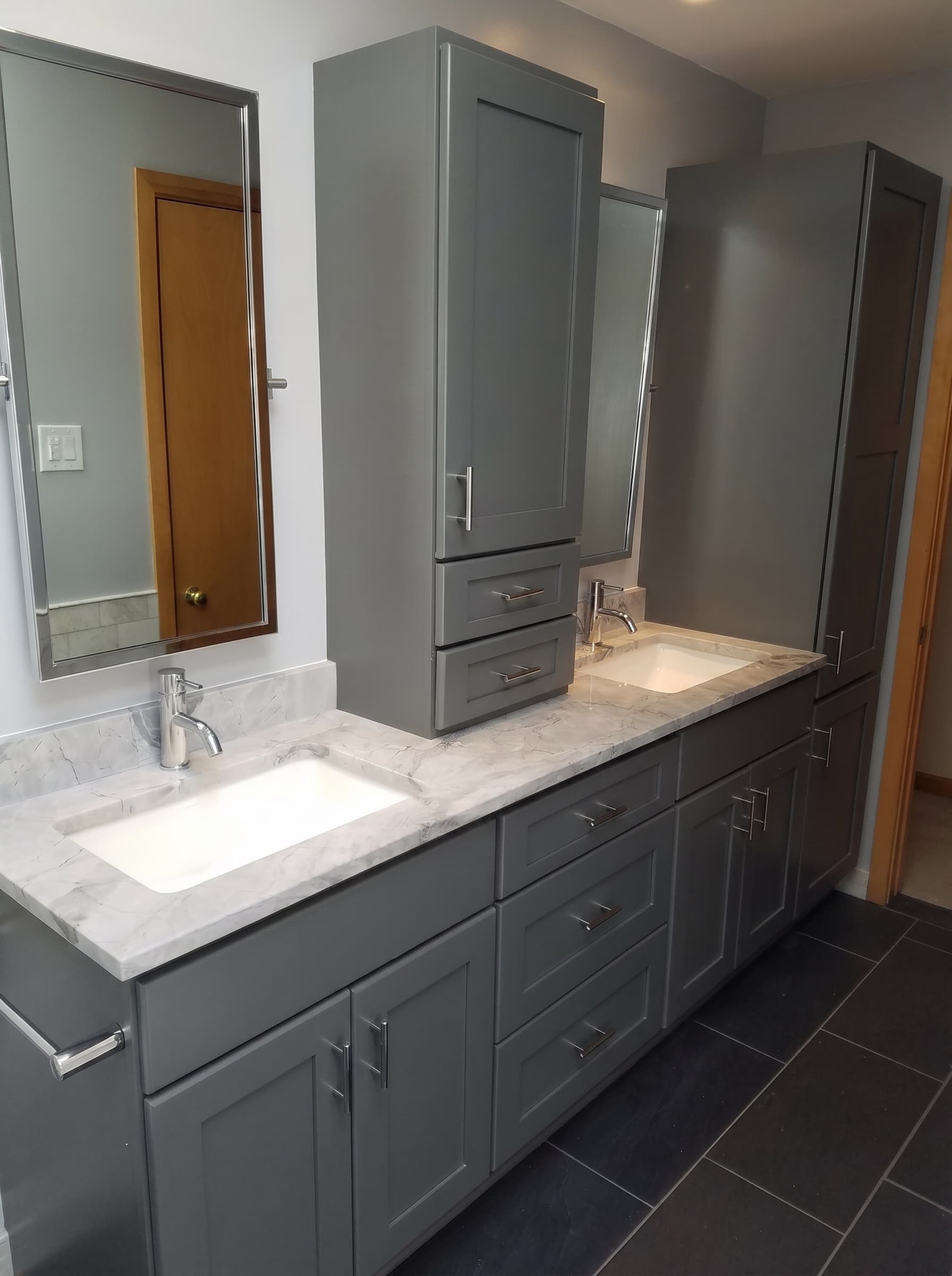 Tile walk-in shower with a dark accent band after a bathroom remodel in Buckingham