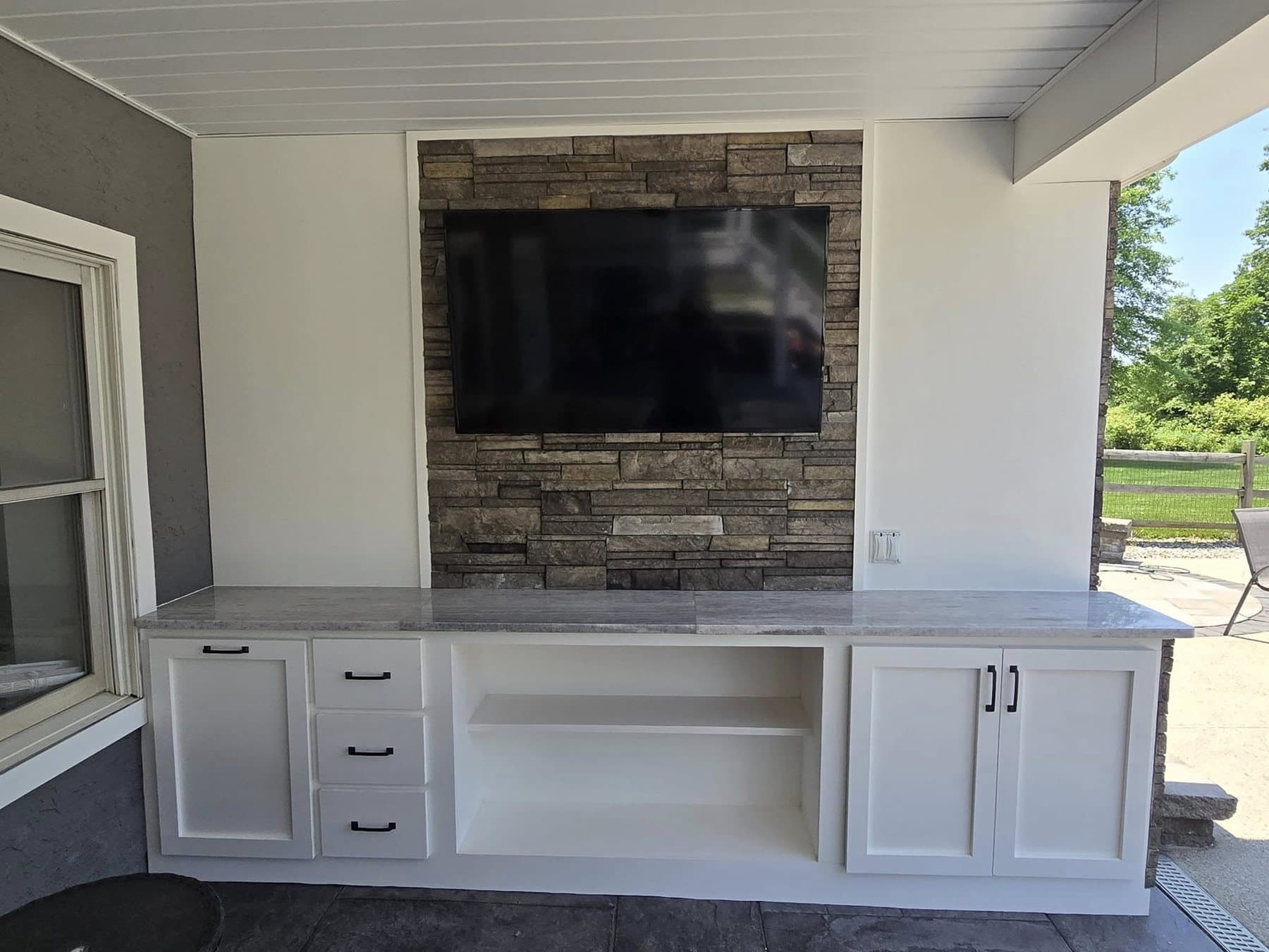 Outdoor TV and fireplace wall from an outdoor living project in Doylestown, PA