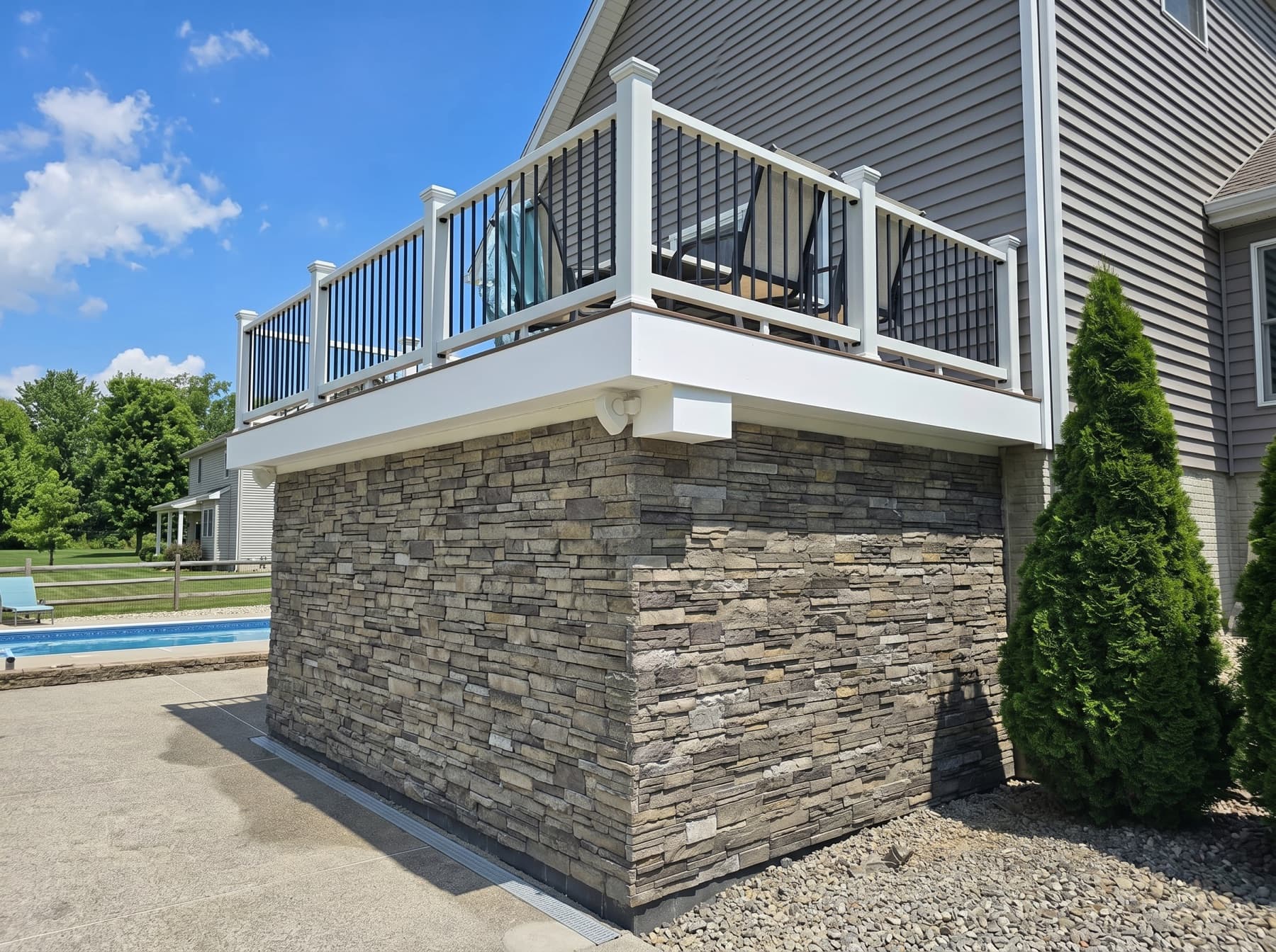 Stone base under a raised deck from an outdoor living project in Doylestown, PA