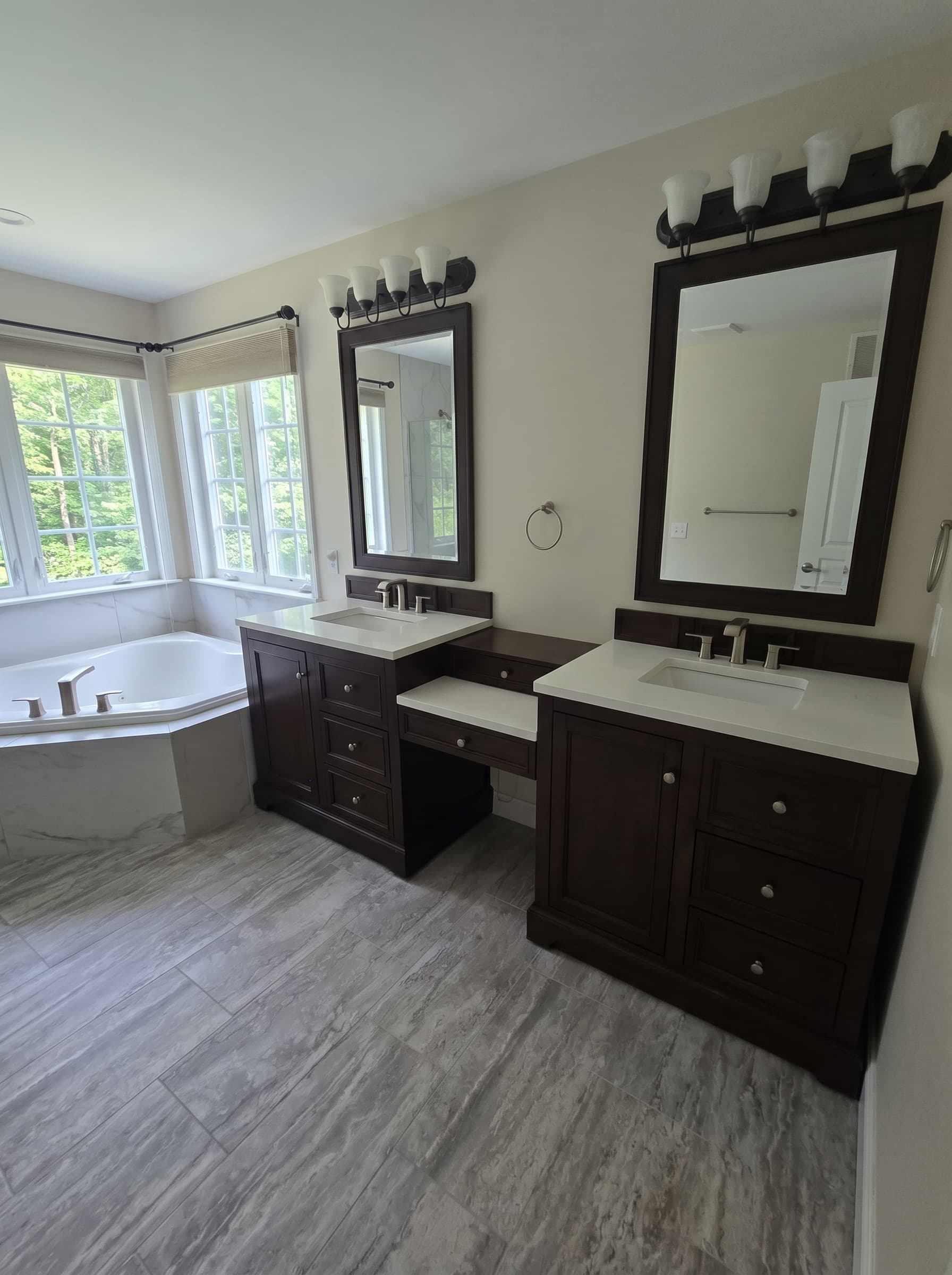 Finished Fountainville primary bathroom with double vanity and corner soaking tub