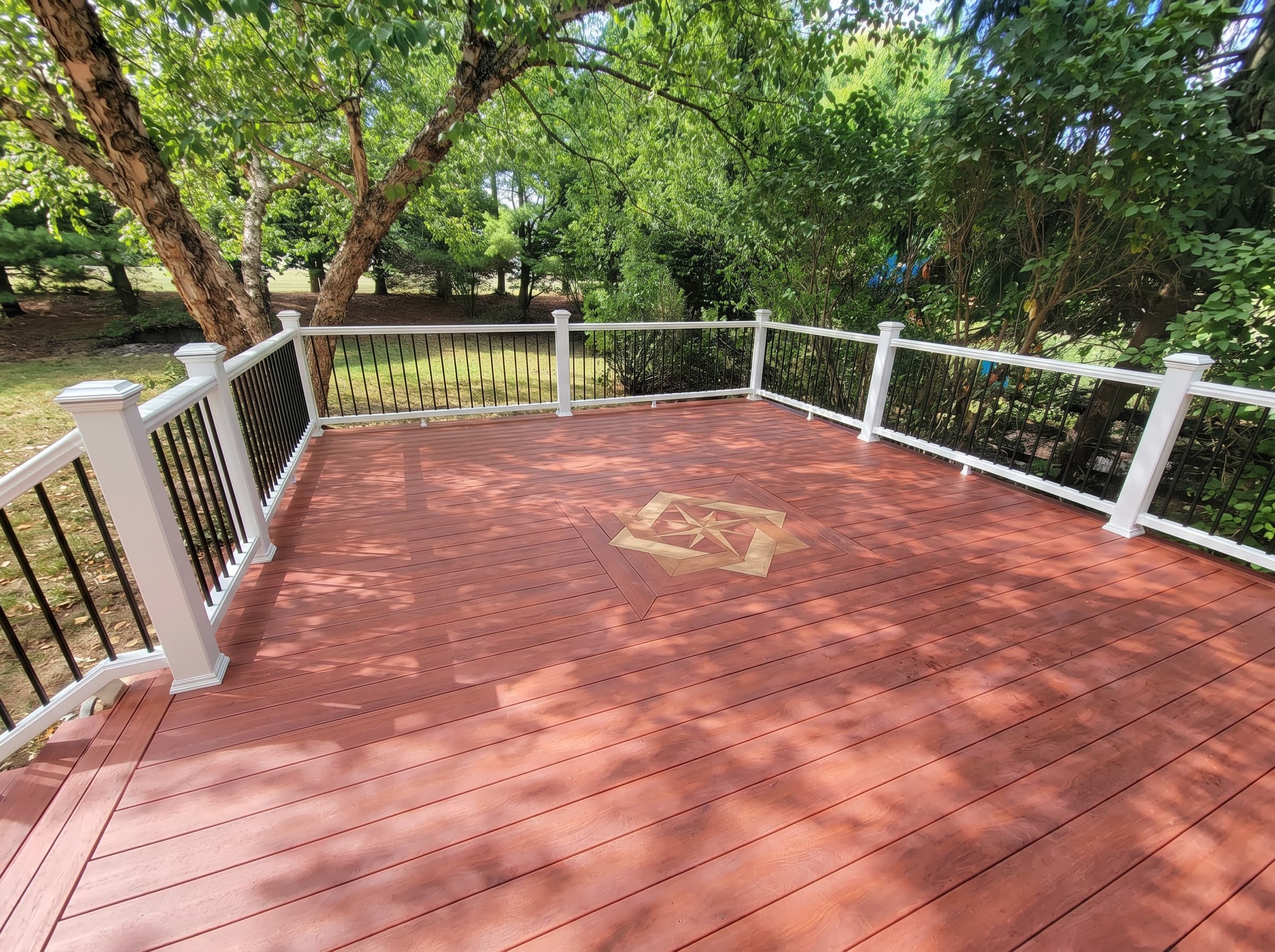Finished New Hope deck with white railing and custom inlay