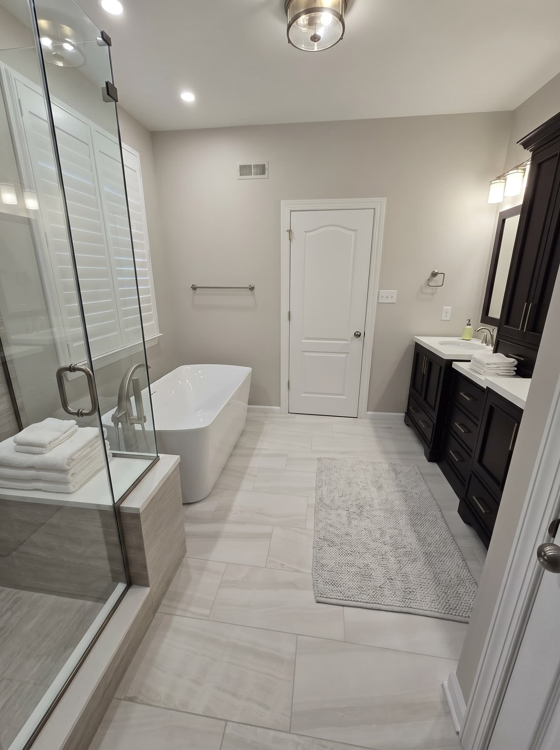 Finished New Hope bathroom with glass shower, soaking tub, and dark vanity