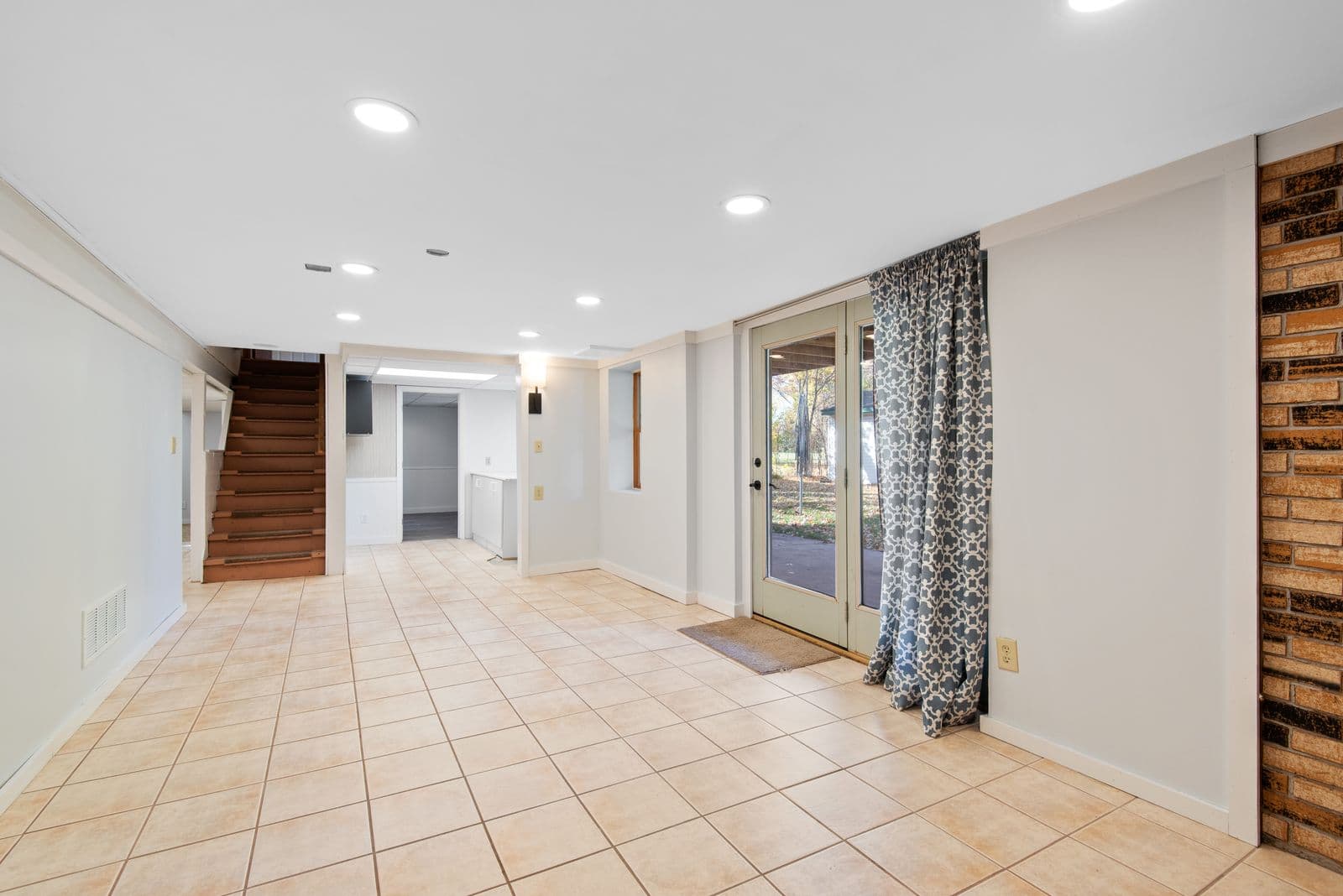 Basement with a walkout door and stairs to the main floor