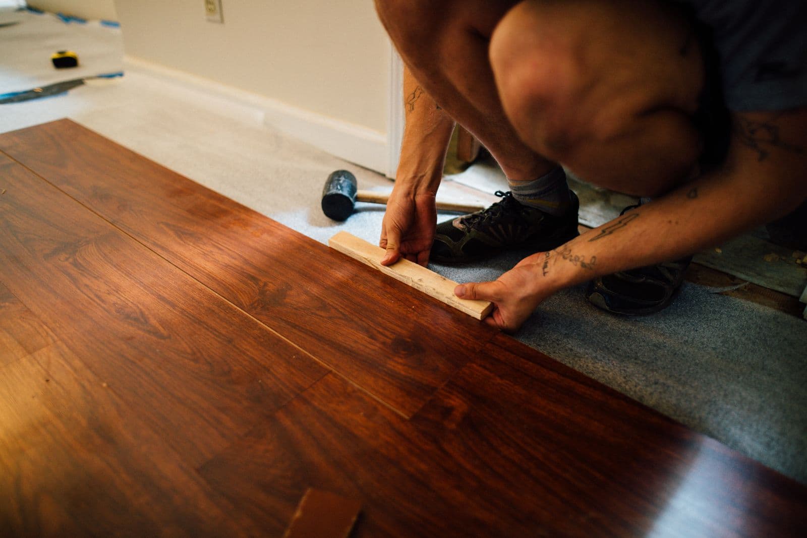 Plank flooring being installed over a subfloor