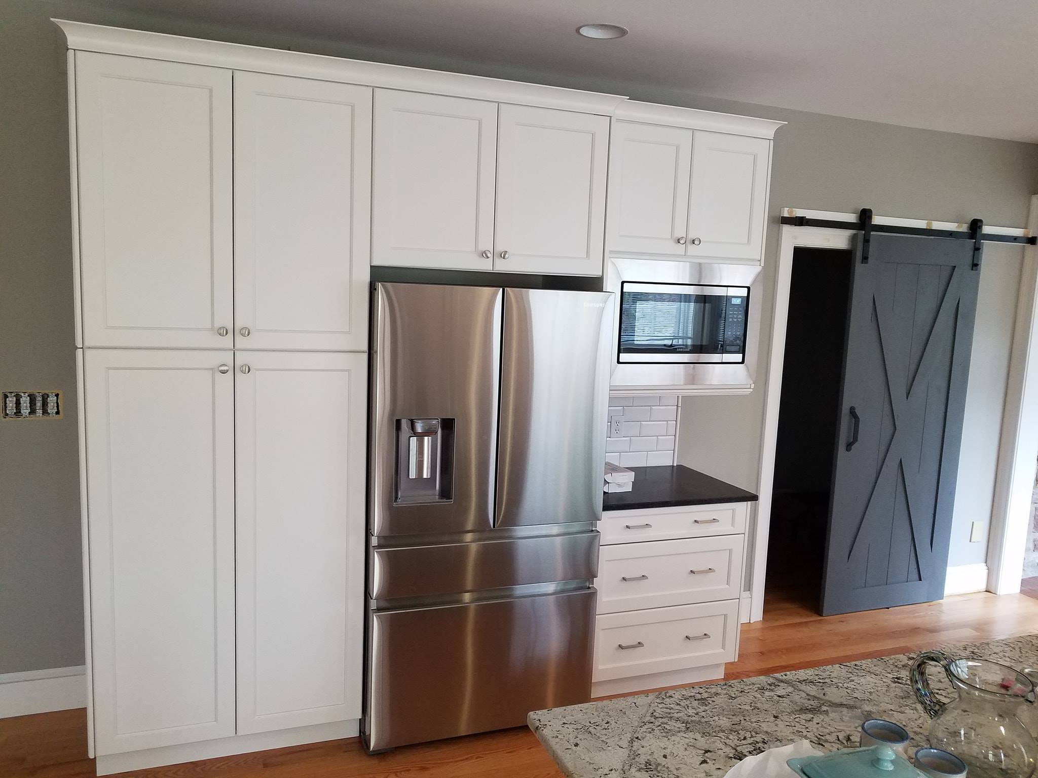 Newly remodeled kitchen with cabinets around fridge
